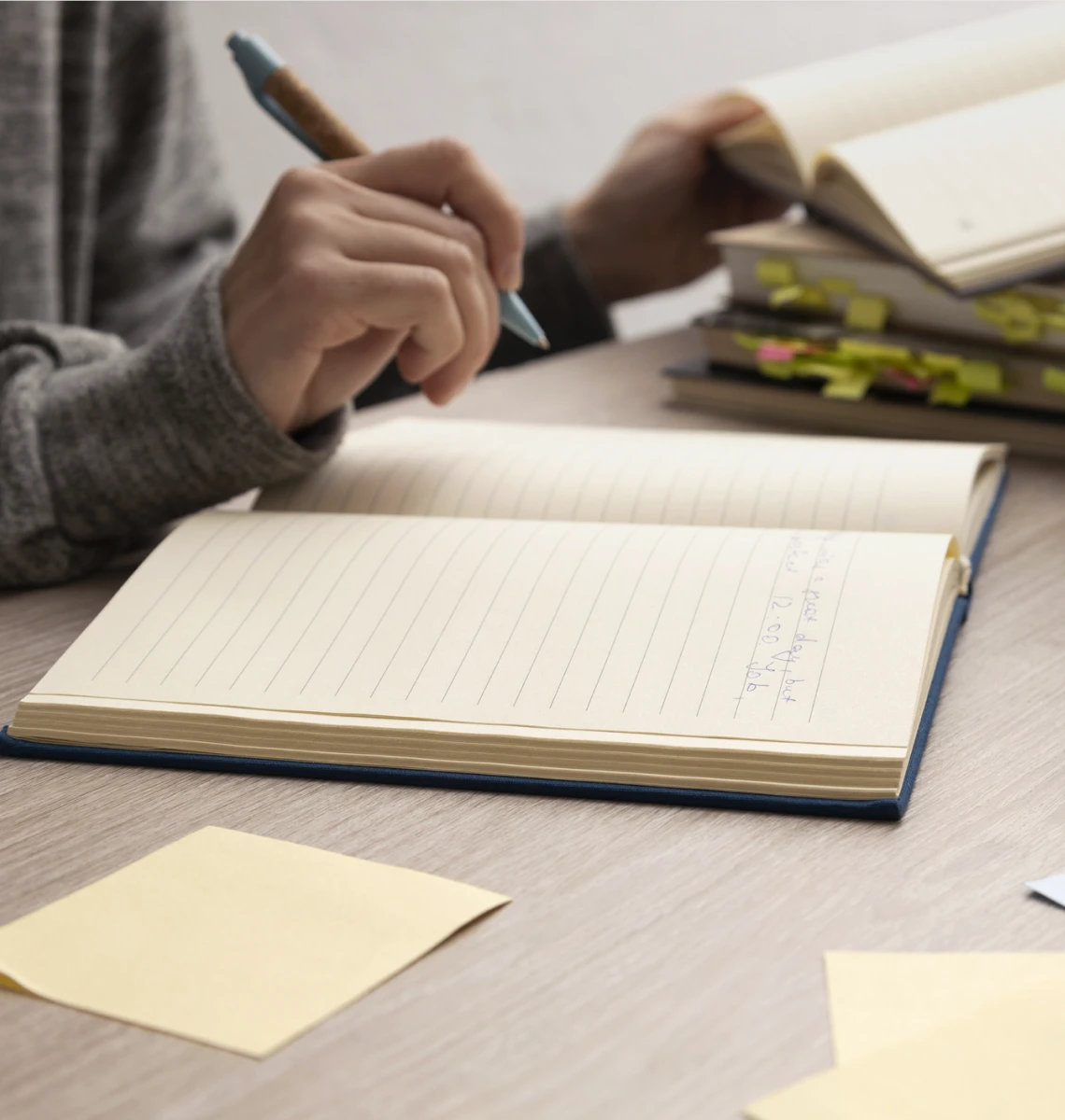 Open notebook with pen and sticky notes