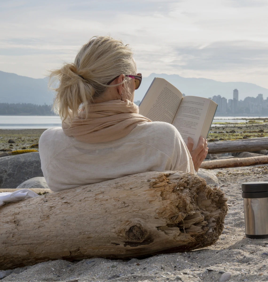 Scenic beach reading with thermos nearby